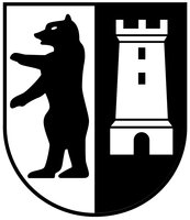 Wappen: In gespaltenem Schild links auf weißem Grund ein aufgerichteter schwarzer Bär, rechts auf schwarzem Grund ein weißer Zinnenturm.